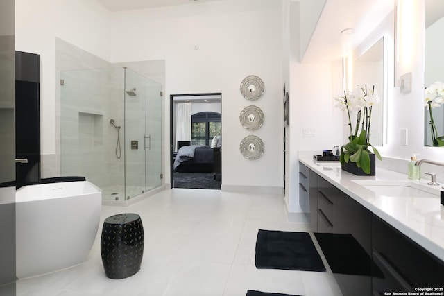 bathroom with vanity, tile patterned floors, and shower with separate bathtub