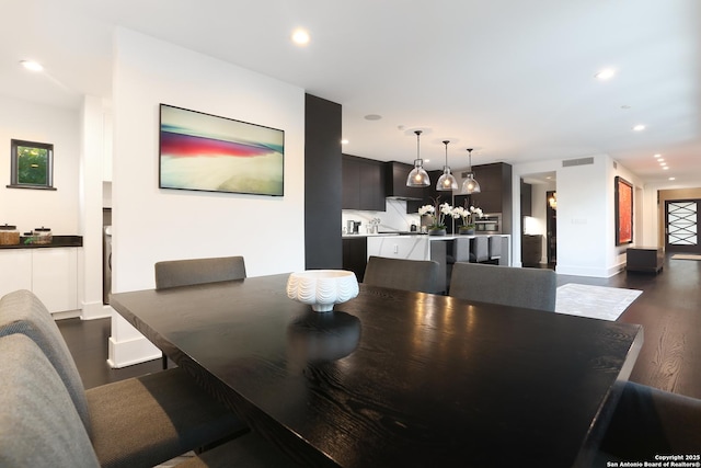 dining space featuring dark hardwood / wood-style flooring