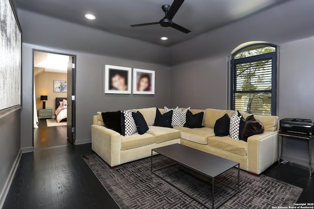 living room with ceiling fan and dark hardwood / wood-style floors