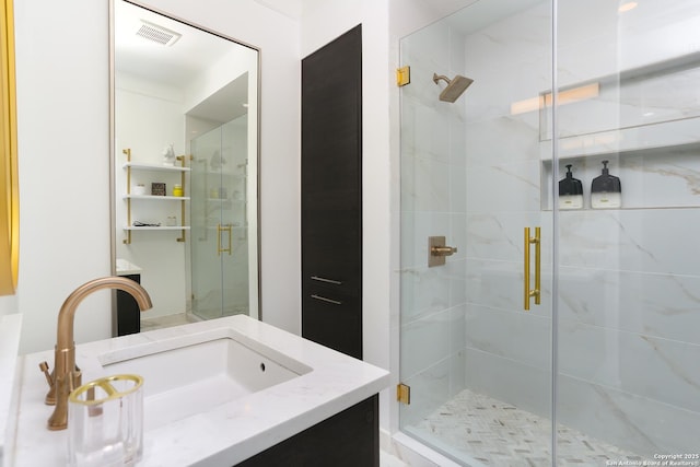 bathroom with vanity and a shower with door