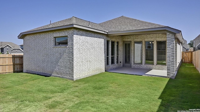 2607 Vistablue Ln, San Antonio, TX 78245 - back of house featuring roof with shingles, a patio, and brick siding