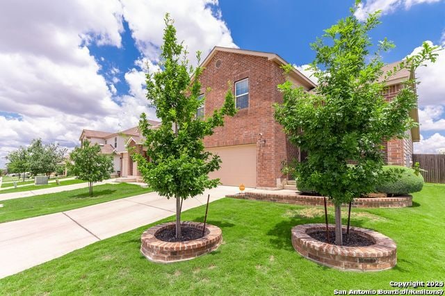 view of front of property with a garage and a front lawn