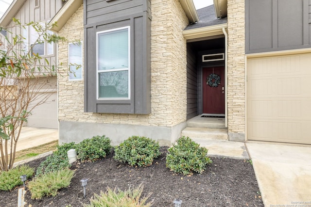 doorway to property with a garage