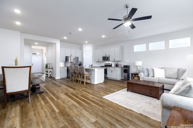 living room with sink, dark hardwood / wood-style floors, and ceiling fan