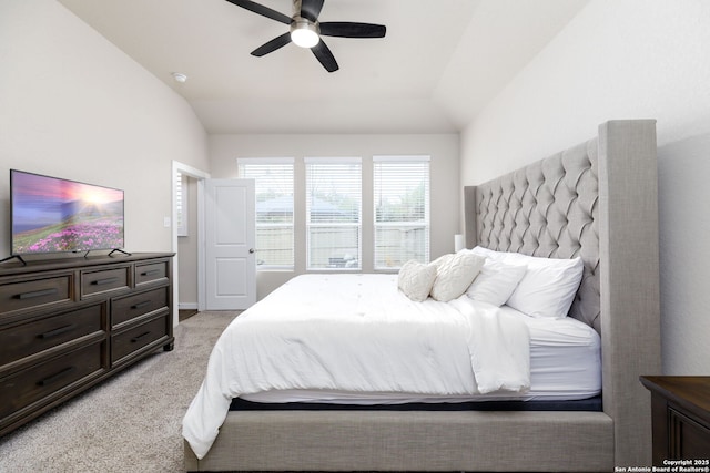 bedroom with ceiling fan, light colored carpet, and lofted ceiling