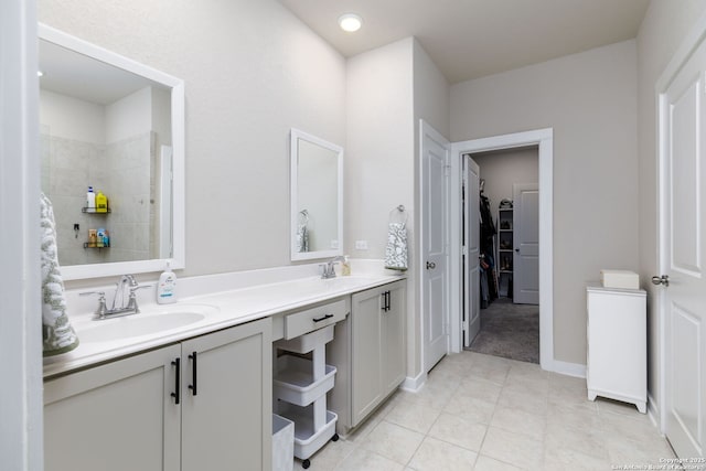 bathroom featuring vanity, tile patterned floors, and walk in shower