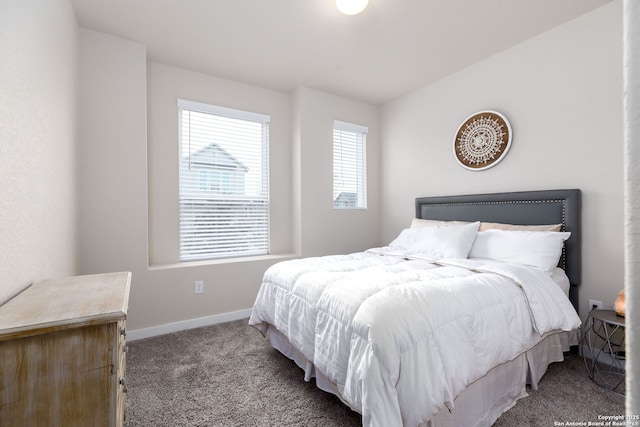 bedroom with light colored carpet and lofted ceiling