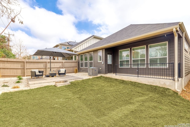 back of house with a yard, a patio, and central air condition unit