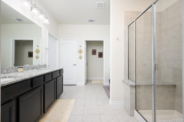 bathroom featuring tile patterned flooring, an enclosed shower, and vanity