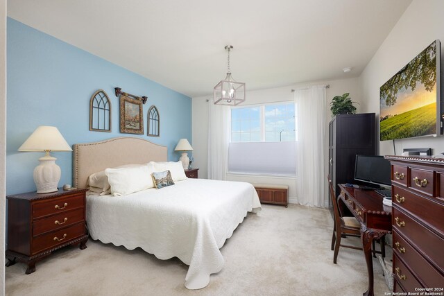 bedroom with light carpet and a notable chandelier