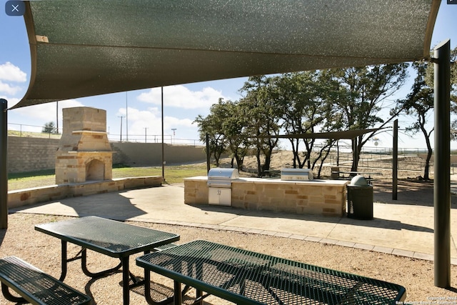 view of community featuring exterior kitchen and a patio area