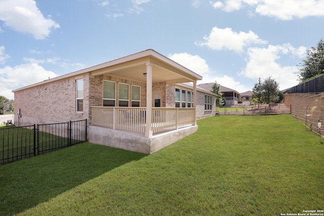 rear view of property with a yard