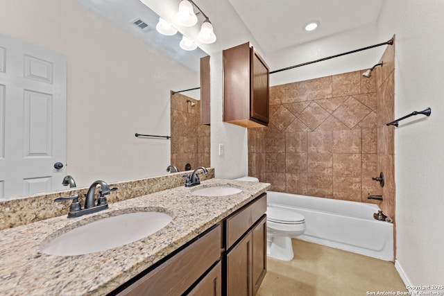 full bathroom with vanity, tiled shower / bath, and toilet