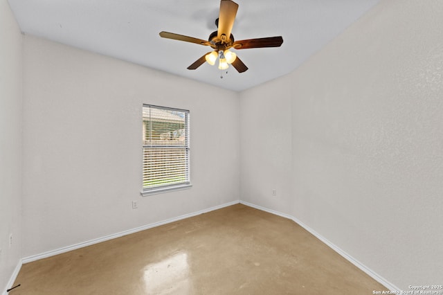 empty room with concrete floors and ceiling fan