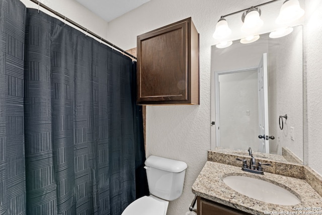 bathroom featuring vanity, a shower with shower curtain, and toilet