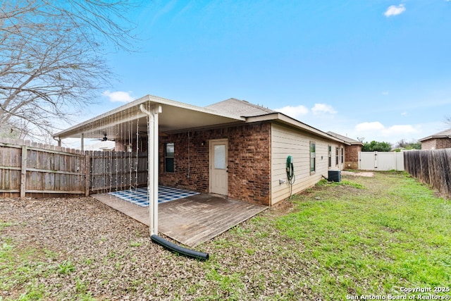 rear view of house with a patio and a lawn