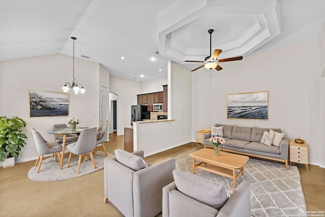 living room featuring lofted ceiling and ceiling fan with notable chandelier