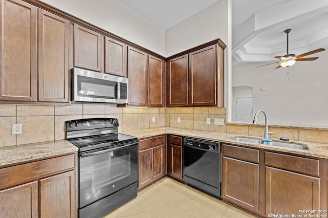 kitchen featuring sink, backsplash, ceiling fan, black appliances, and light stone countertops