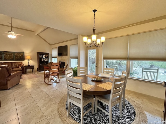 dining room featuring light tile patterned floors, ceiling fan with notable chandelier, vaulted ceiling, and a healthy amount of sunlight