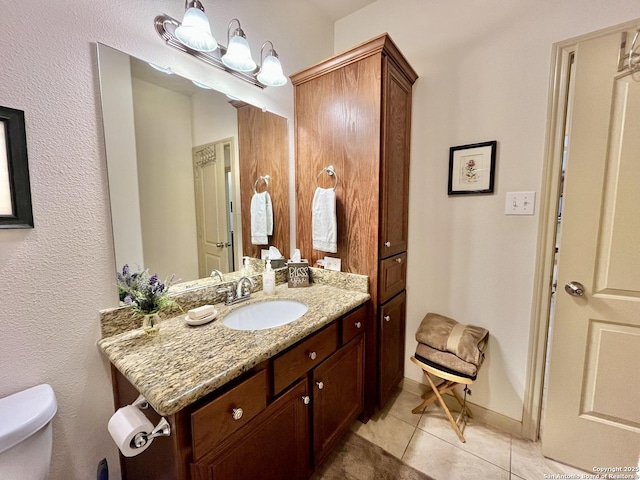 bathroom featuring vanity, tile patterned floors, and toilet