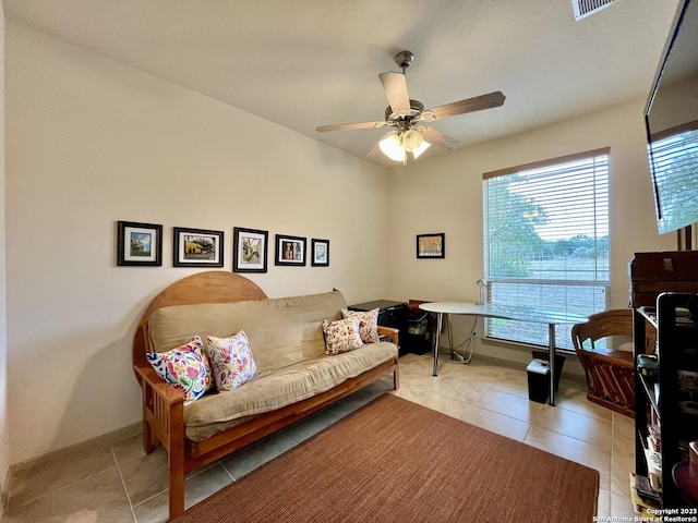 interior space with ceiling fan and light tile patterned floors