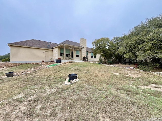 rear view of house with a lawn