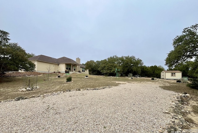 view of yard with a storage shed