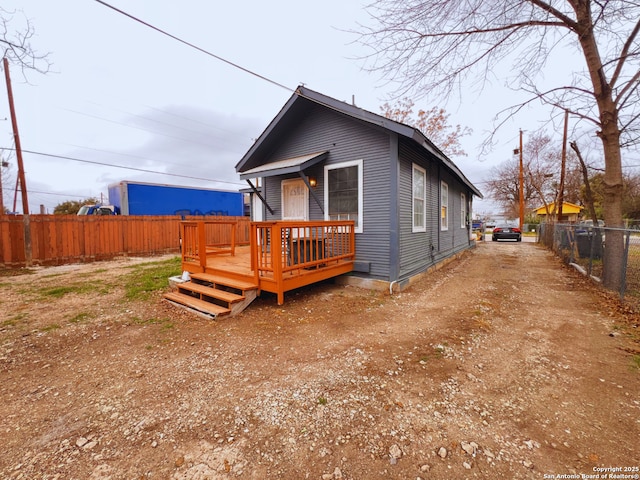 back of property featuring a wooden deck