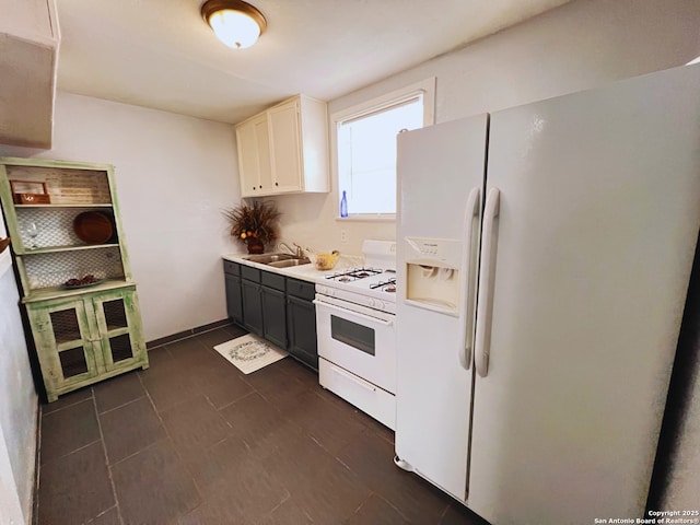 kitchen with white cabinetry, sink, and white appliances