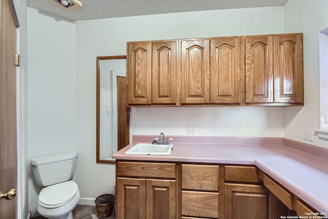 kitchen featuring sink and a textured ceiling