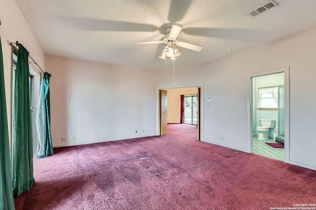 carpeted empty room with ceiling fan, a healthy amount of sunlight, and a textured ceiling