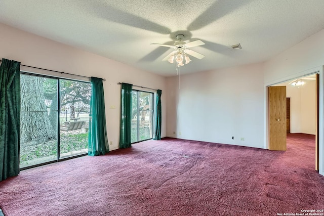 empty room with ceiling fan, carpet, and a textured ceiling