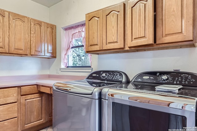 laundry area featuring cabinets and washing machine and clothes dryer