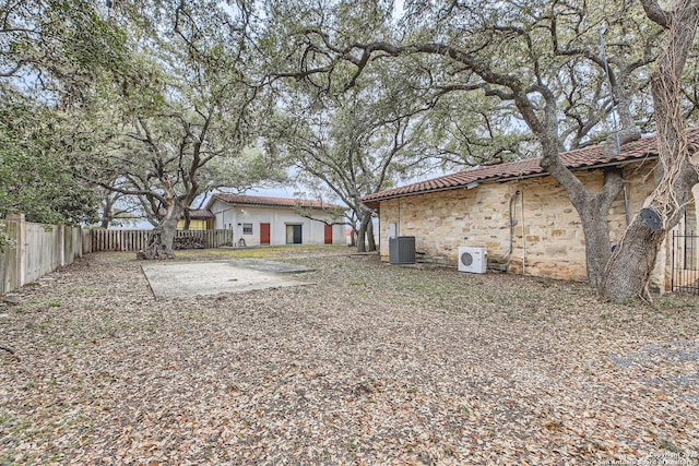 view of yard featuring cooling unit, ac unit, and a patio