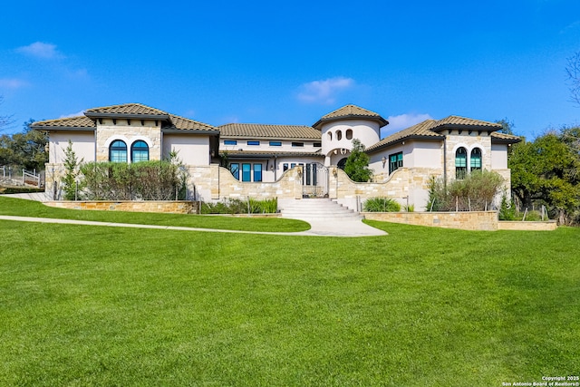 mediterranean / spanish house with a front lawn