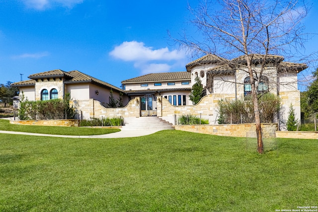 mediterranean / spanish house featuring a front yard