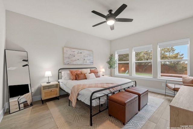 bedroom with ceiling fan and light wood-type flooring