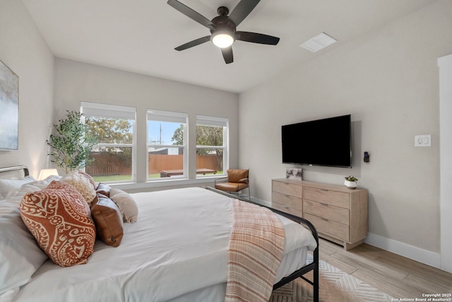 bedroom with light hardwood / wood-style flooring and ceiling fan