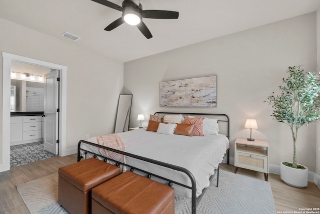 bedroom featuring connected bathroom, wood-type flooring, and ceiling fan