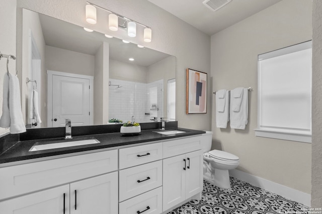 bathroom with vanity, toilet, a shower with shower door, and tile patterned flooring