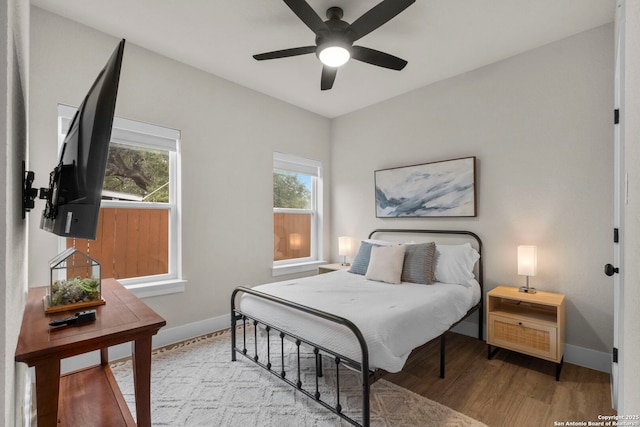 bedroom with ceiling fan and light wood-type flooring