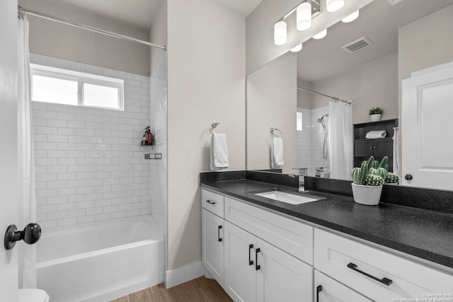 bathroom featuring vanity, hardwood / wood-style flooring, and shower / bath combo