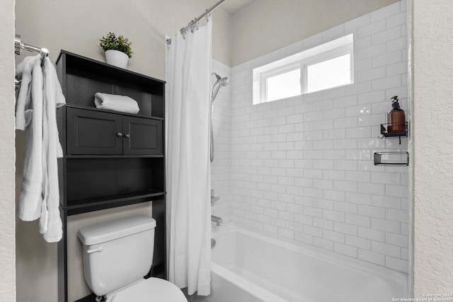 bathroom featuring shower / tub combo with curtain and toilet