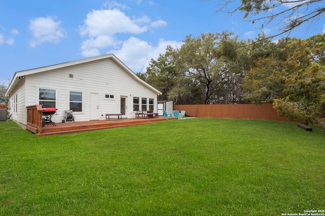 back of property with a yard and a deck