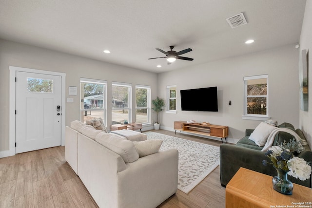 living room featuring ceiling fan and light hardwood / wood-style flooring