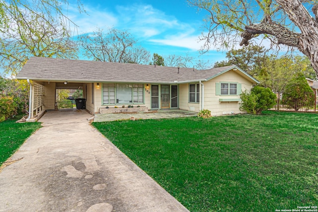 ranch-style house featuring a front yard and a carport