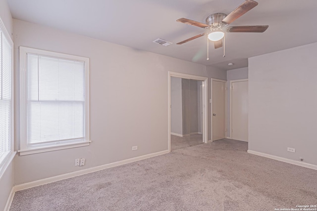 unfurnished bedroom with ceiling fan and light carpet