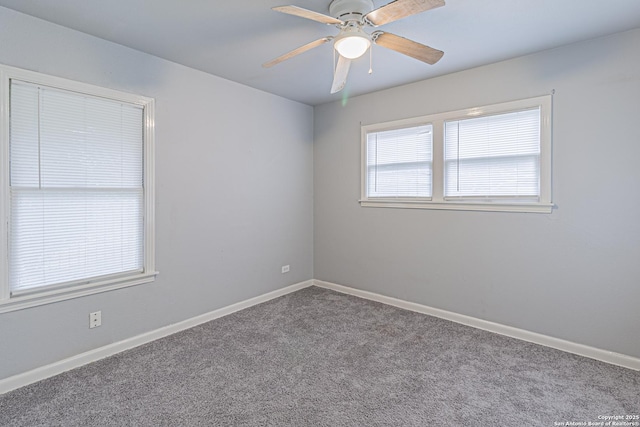 carpeted spare room featuring ceiling fan