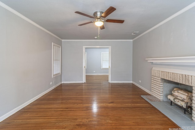 unfurnished living room with crown molding, ceiling fan, a fireplace, and dark hardwood / wood-style flooring