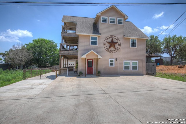 view of front of house with a balcony and a garage